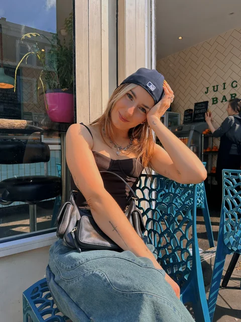 Abi sitting outside a café.